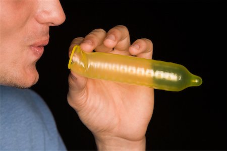 simsearch:625-01252359,k - Close-up of a young man blowing a condom Stock Photo - Premium Royalty-Free, Code: 625-00850691