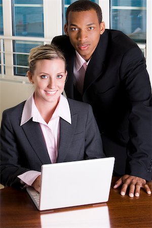 simsearch:625-00851478,k - Portrait of a businessman and a businesswoman in front of a laptop Stock Photo - Premium Royalty-Free, Code: 625-00850845