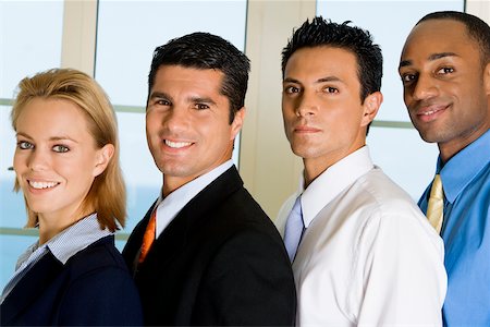 Side profile of three businessmen and a businesswoman standing in a row Stock Photo - Premium Royalty-Free, Code: 625-00850906