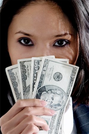 Portrait of a businesswoman holding American dollar bills Fotografie stock - Premium Royalty-Free, Codice: 625-00850921