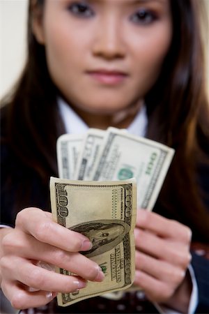 simsearch:625-00850993,k - Portrait of a businesswoman holding one hundred dollar bills Stock Photo - Premium Royalty-Free, Code: 625-00851006