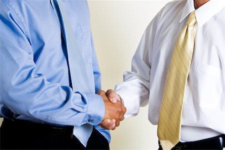 Mid section view of two businessmen shaking hands Stock Photo - Premium Royalty-Free, Code: 625-00851029