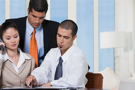 simsearch:625-00851478,k - Portrait of two businessmen and a businesswoman in an office Stock Photo - Premium Royalty-Free, Code: 625-00851050