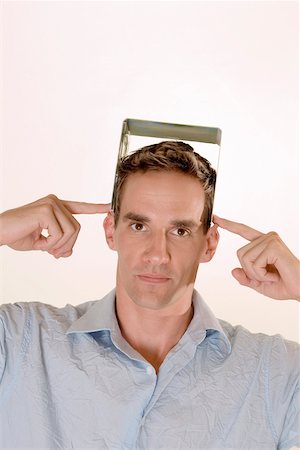 Portrait of a mid adult man holding a CD case on his head Stock Photo - Premium Royalty-Free, Code: 625-00851052