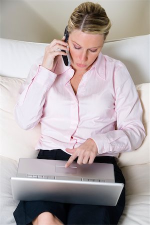 simsearch:625-01261416,k - High angle view of a businesswoman talking on a mobile phone while working on a laptop Foto de stock - Royalty Free Premium, Número: 625-00851165