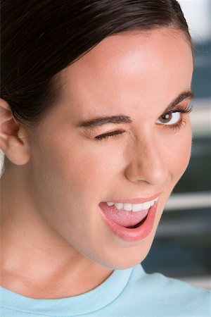 Close-up of a young woman winking Stock Photo - Premium Royalty-Free, Code: 625-00851162