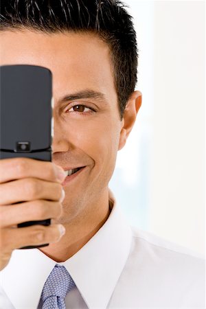 simsearch:625-02266709,k - Close-up of a businessman holding a mobile phone Foto de stock - Sin royalties Premium, Código: 625-00851171
