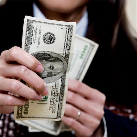 simsearch:625-00850993,k - Close-up of a businesswoman holding one hundred dollar bills Stock Photo - Premium Royalty-Free, Code: 625-00851283