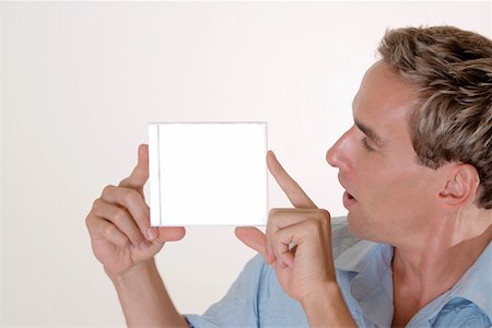 Close-up of a mid adult man holding a CD case Stock Photo - Premium Royalty-Free, Code: 625-00851296