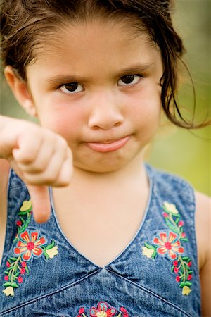 pulgares hacia abajo - Portrait of a girl showing thumbs down Foto de stock - Sin royalties Premium, Código: 625-00851307