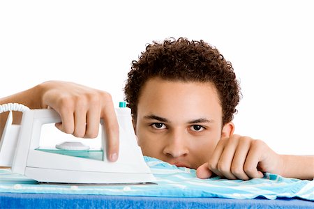 simsearch:625-00841323,k - Portrait of a young man ironing Stock Photo - Premium Royalty-Free, Code: 625-00851330