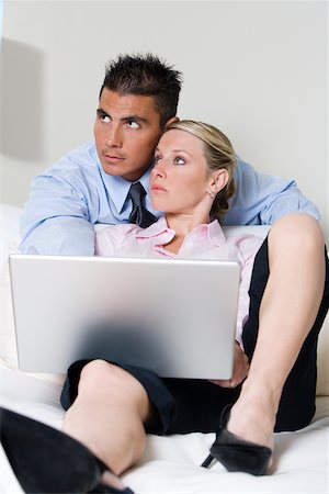 Businessman and a businesswoman using a laptop Stock Photo - Premium Royalty-Free, Code: 625-00851427