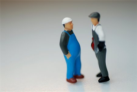 Close-up of the figurines of two construction workers Stock Photo - Premium Royalty-Free, Code: 625-00898241