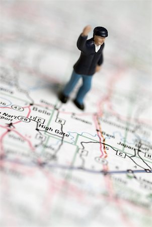 simsearch:625-00898537,k - High angle view of a human figurine on a road map Stock Photo - Premium Royalty-Free, Code: 625-00898475