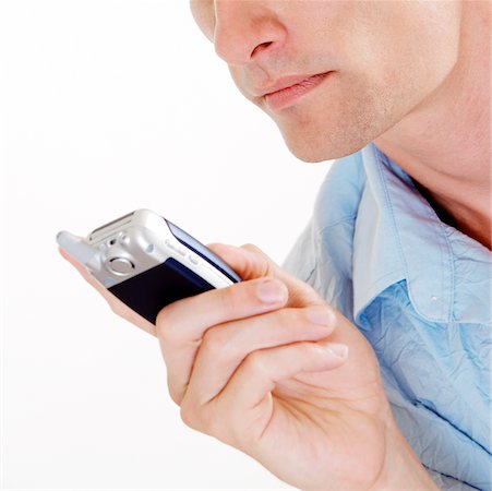 Close-up of a young man holding a mobile phone Stock Photo - Premium Royalty-Free, Code: 625-00899139