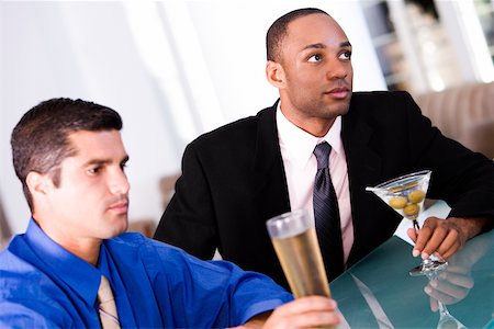 Close-up of two businessmen sitting at a bar counter Stock Photo - Premium Royalty-Free, Code: 625-00899140