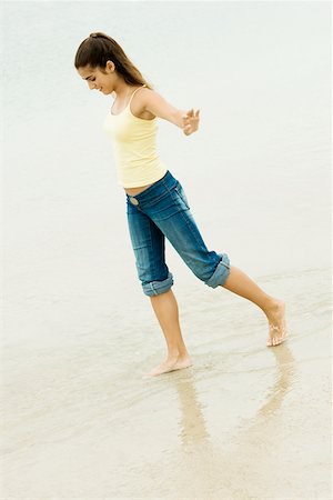 Side profile of a girl walking on the beach Stock Photo - Premium Royalty-Free, Code: 625-00899190