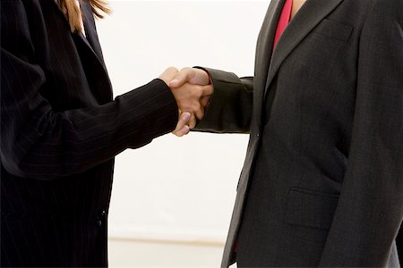 Mid section view of two businesswomen shaking hands Stock Photo - Premium Royalty-Free, Code: 625-00899215