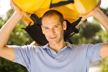 portrait and kayak - Portrait of a young man carrying a kayak on his head Stock Photo - Premium Royalty-Free, Code: 625-00899259