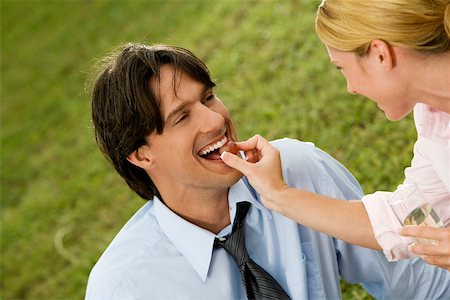 Close-up of a businesswoman feeding a cherry to a businessman Stock Photo - Premium Royalty-Free, Code: 625-00899378