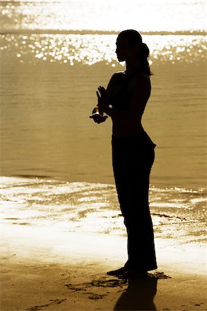 silhouette female martial arts - Silhouette of a young woman practicing martial arts on the beach Stock Photo - Premium Royalty-Free, Code: 625-00899461