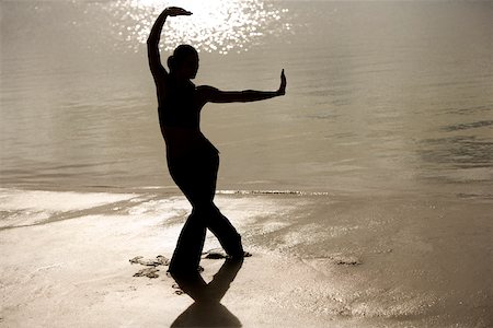 silhouette female martial arts - Silhouette of a young woman practicing martial arts on the beach Stock Photo - Premium Royalty-Free, Code: 625-00899521