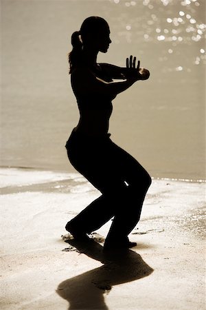 silhouette female martial arts - Silhouette of a young woman practicing martial arts on the beach Stock Photo - Premium Royalty-Free, Code: 625-00899539
