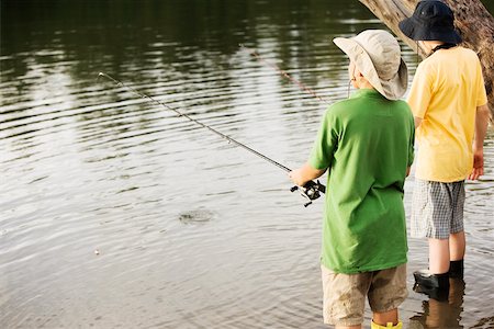 simsearch:625-01038259,k - Rear view of two brothers fishing near a lake Stock Photo - Premium Royalty-Free, Code: 625-00899657