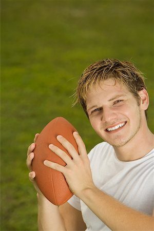 Portrait of a young man holding a rugby ball Stock Photo - Premium Royalty-Free, Code: 625-00899751