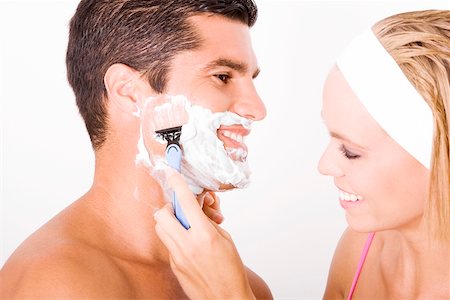 shaving man woman - Close-up of a young woman shaving a mid adult man's face Stock Photo - Premium Royalty-Free, Code: 625-00899857