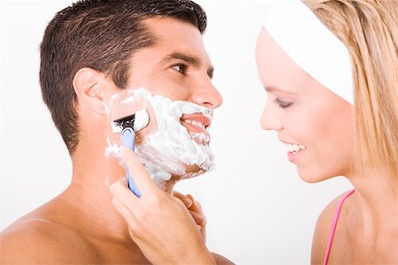 shaving man woman - Close-up of a young woman shaving a mid adult man's face Stock Photo - Premium Royalty-Free, Code: 625-00899862