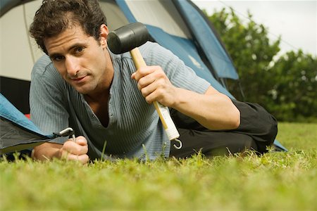 Portrait of a mid adult man putting up a tent Stock Photo - Premium Royalty-Free, Code: 625-00899999