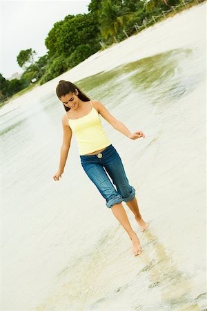 Girl wading in water on the beach Stock Photo - Premium Royalty-Free, Code: 625-00900009