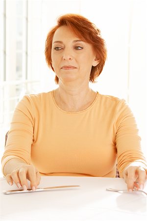simsearch:625-01093661,k - Close-up of a senior woman seated at the table looking away Stock Photo - Premium Royalty-Free, Code: 625-00900218