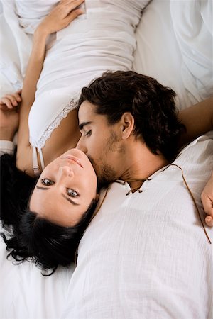 double bedroom - High angle view of a young man kissing a young woman Stock Photo - Premium Royalty-Free, Code: 625-00900337