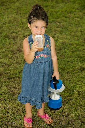 slippers girls - Portrait of a girl holding a baby bottle and a lantern Stock Photo - Premium Royalty-Free, Code: 625-00900331