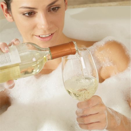 Close-up of a young woman pouring champagne in a champagne flute Stock Photo - Premium Royalty-Free, Code: 625-00900427