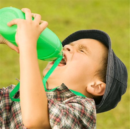 Close-up of a boy drinking water from a water bottle Stock Photo - Premium Royalty-Free, Code: 625-00900460