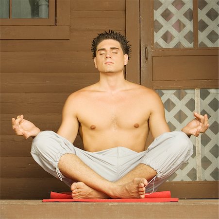 simsearch:625-00839293,k - Close-up of a bare chested young man sitting in a lotus position and meditating Stock Photo - Premium Royalty-Free, Code: 625-00900609