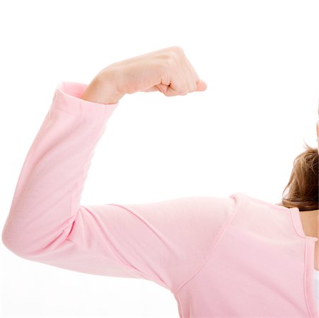 Close-up of a girl flexing her bicep Stock Photo - Premium Royalty-Free, Code: 625-00900796