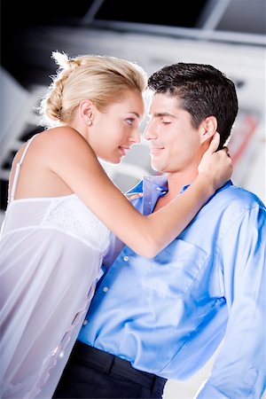 Side profile of a young woman and a mid adult man embracing each other Stock Photo - Premium Royalty-Free, Code: 625-00900914