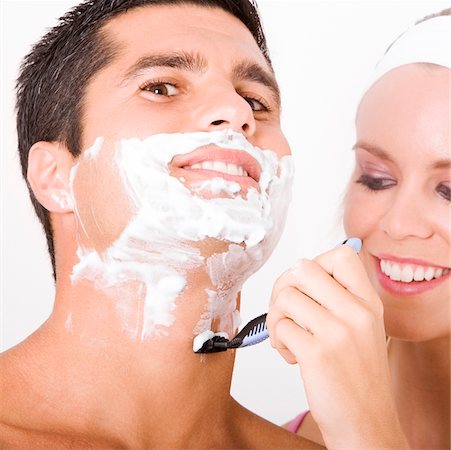shaving man woman - Close-up of a young woman shaving a mid adult man's face Stock Photo - Premium Royalty-Free, Code: 625-00901011