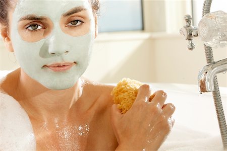 sponge bath woman - Close-up of a young woman scrubbing herself with a sponge Stock Photo - Premium Royalty-Free, Code: 625-00901038