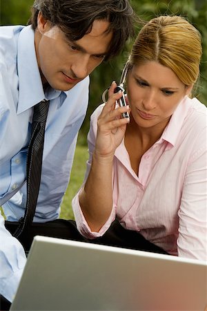 simsearch:625-01261416,k - Close-up of a businessman and a businesswoman working on a laptop and talking on a mobile phone Foto de stock - Royalty Free Premium, Número: 625-00901079
