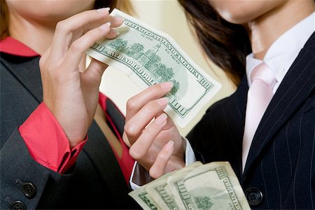 simsearch:625-00850993,k - Mid section view of two businesswomen holding dollar bills Stock Photo - Premium Royalty-Free, Code: 625-00901090
