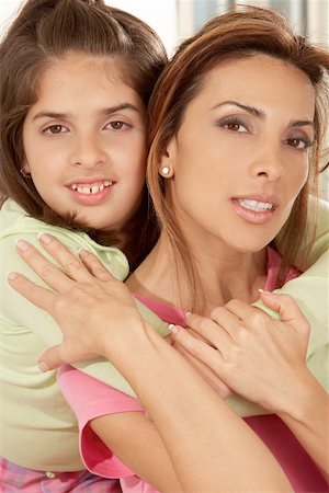 simsearch:632-02416107,k - Portrait of a daughter hugging her mother from behind Stock Photo - Premium Royalty-Free, Code: 625-00901253