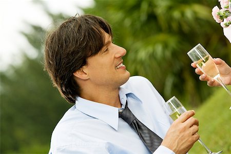 Close-up of a businessman and a woman holding champagne flutes Stock Photo - Premium Royalty-Free, Code: 625-00901331