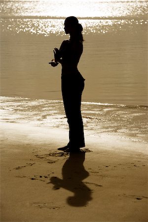 silhouette female martial arts - Silhouette of a young woman practicing martial arts on the beach Stock Photo - Premium Royalty-Free, Code: 625-00901439