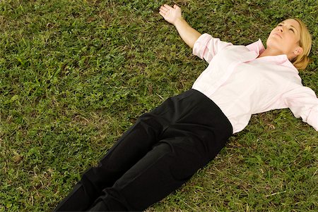 simsearch:625-02932995,k - High angle view of a businesswoman lying on the grass Stock Photo - Premium Royalty-Free, Code: 625-00901661