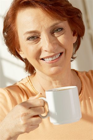 Portrait of a senior woman holding a coffee cup Stock Photo - Premium Royalty-Free, Code: 625-00901663